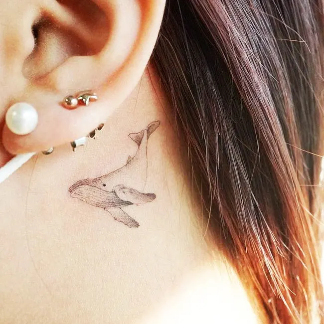 A whale tattoo behind the ear by @mijeongtattoo