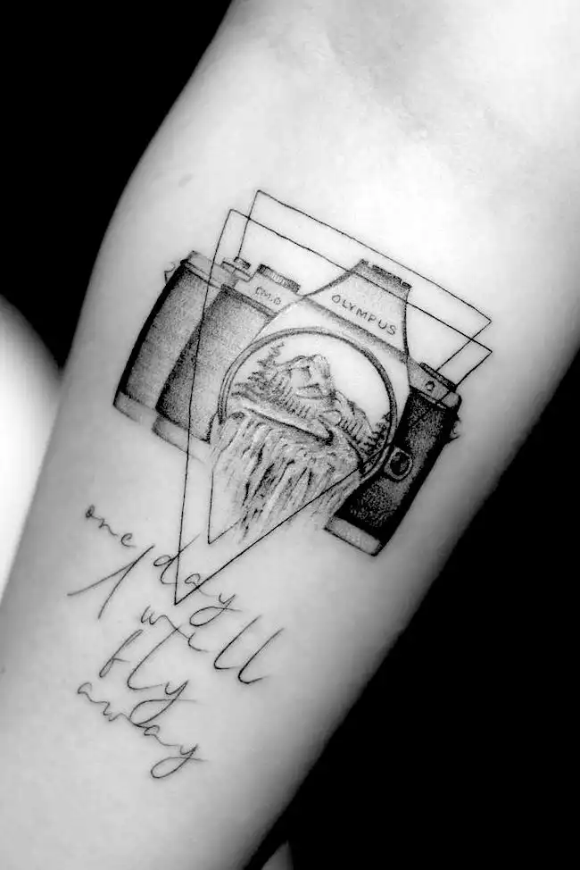 A camera tattoo by @mr.ok_tattoo
