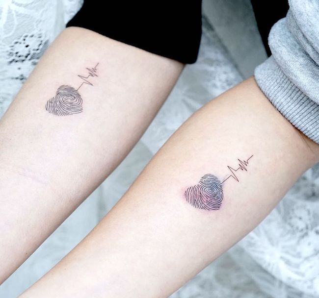 Matching fingerprint heartbeat tattoos by @hktattoo_tina