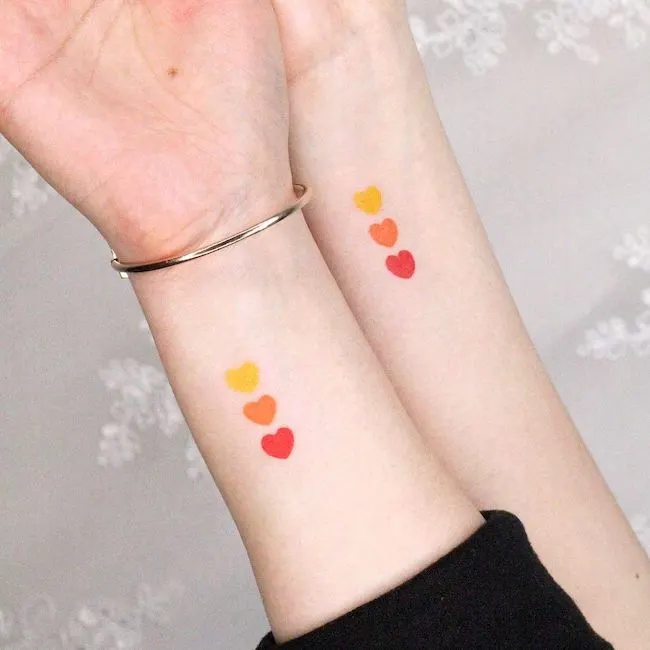 Triple hearts wrist tattoos by @simya_tattoo