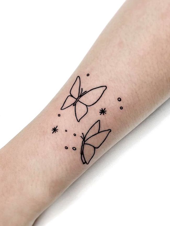Butterfly outline wrist tattoo by @tattooist_mauve