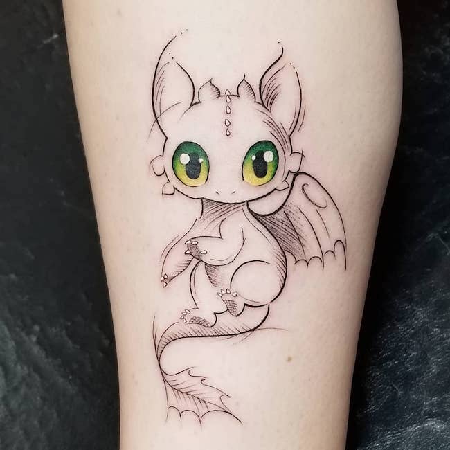 Cute Toothless tattoo by @jessicatattoos- best dragon tattoos for women and girls