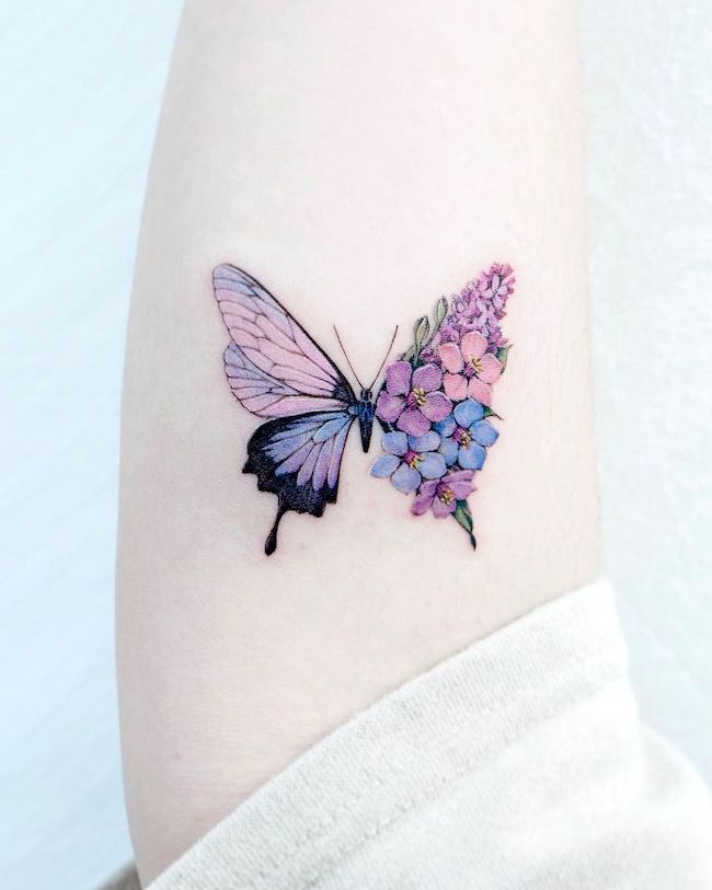 Half-butterfly half-flower arm tattoo by @tattooist_color.b