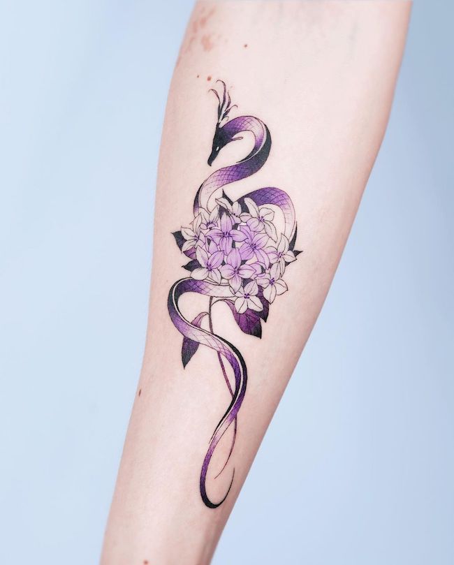 Purple dragon and daphnes for girls by @e.nal_.tattoo- best dragon tattoos for women and girls