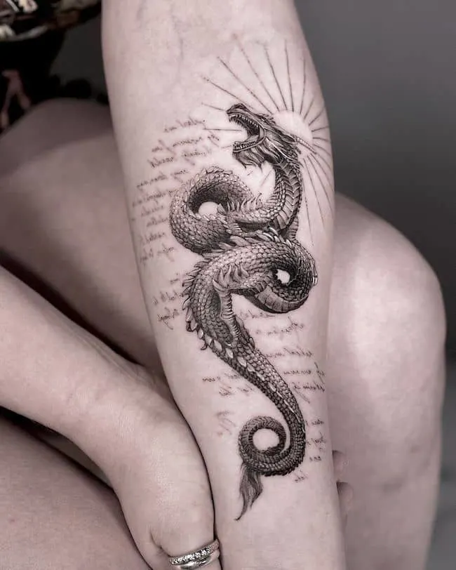 Arm tatoo of a dragon starting from the elbow wrapping around t   Arthubai