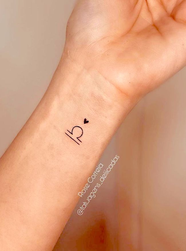 Small Libra symbol wrist tattoo by @tatuagens_deliicadas