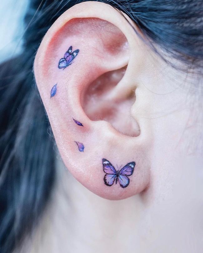 Small butterfly ear tattoo by @tattooist_color.b