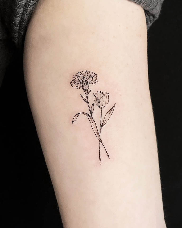 Carnation and tulip arm tattoo by @coralsicobotattoo
