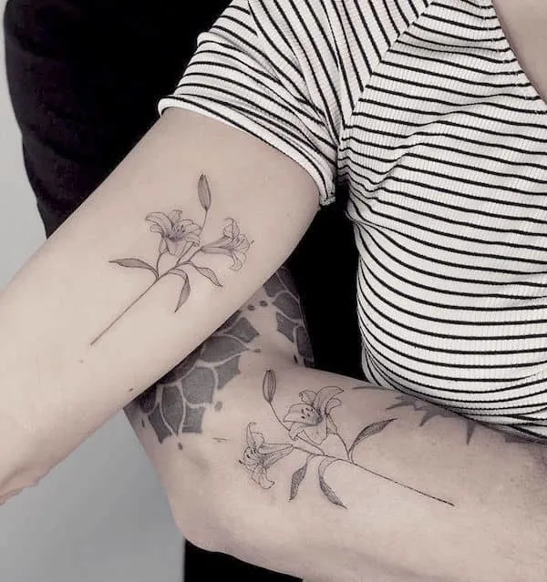 Matching lily tattoos for couples by @emmaflorestattoo - Lily flower tattoos with meaning
