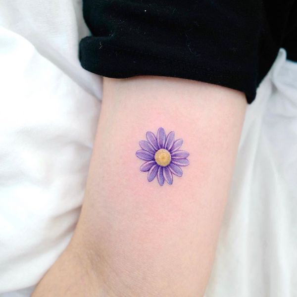 Purple daisy tattoo by @xiso_ink- Daisy flower tattoos with meaning