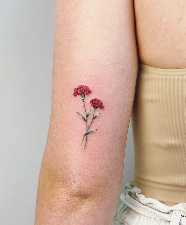 Red carnation arm tattoo by @fervescentattoo