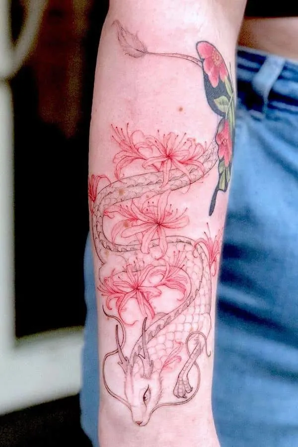 Red spider lily and dragon tattoo on the arm by @kikiraventattoo -Red spider lily flower tattoos with meaning
