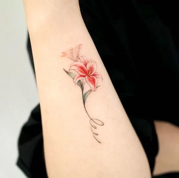 Stargazer lily and initial tattoo by @abii_tattoo