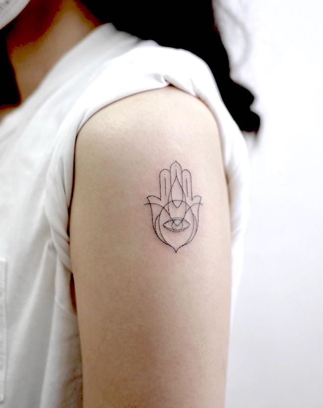 Hamsa hand shoulder tattoo by @iotattooing- Classy black and white shoulder tattoos for women