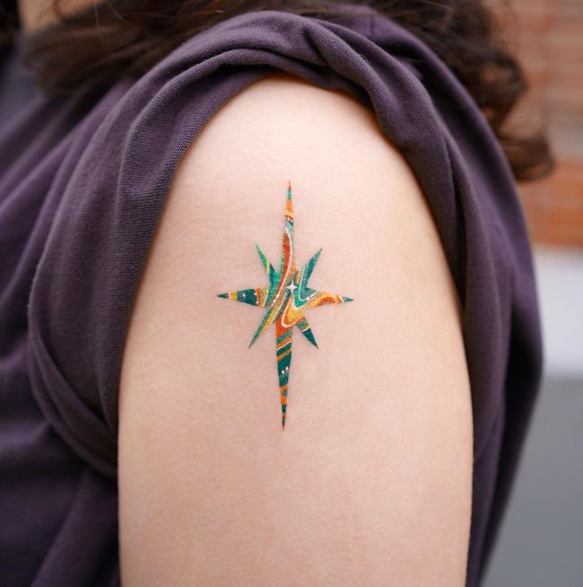 Marbling star tattoo by @o.ri_tattoo- Cute colored shoulder tattoos for women