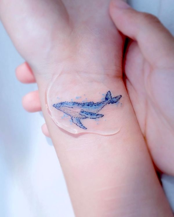 Beautiful whale wrist tattoo for women by @haenal_tattoo