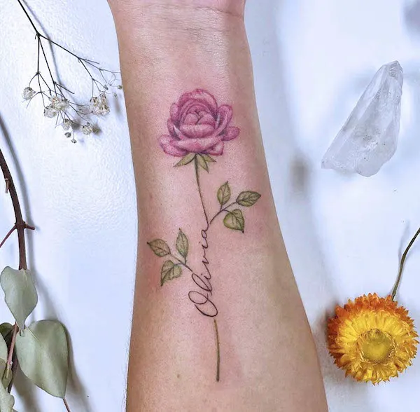 Elegant rose and name inner wrist tattoo by @light_grey_studio