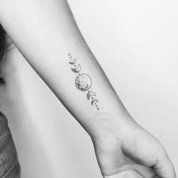 Feminine moon and leaves wrist tattoo by @anaguti.tattoo