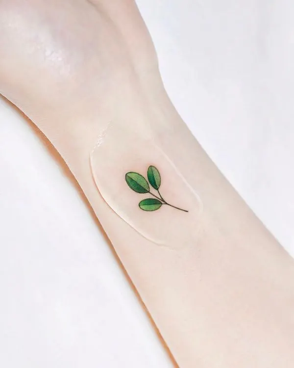 Minimalist tiny leaf tattoo on the wrist by @tattooist_dree
