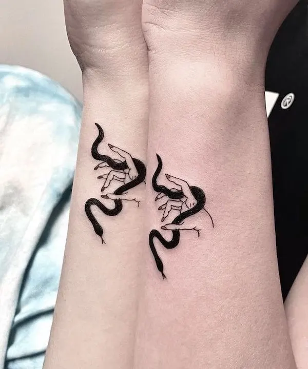 Playing with snake side wrist tattoos by @atar_bar