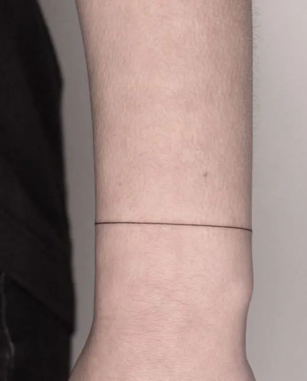 Simple one line wrap around bracelet tattoo by @bymosler- Wrap around bracelet wrist tattoos