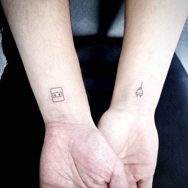 Socket and plug matching couple wrist tattoos by @tocinoink