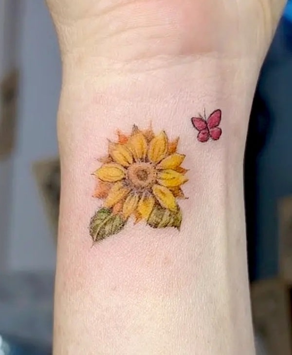 Sunflower inner wrist tattoo by @dawon.ink