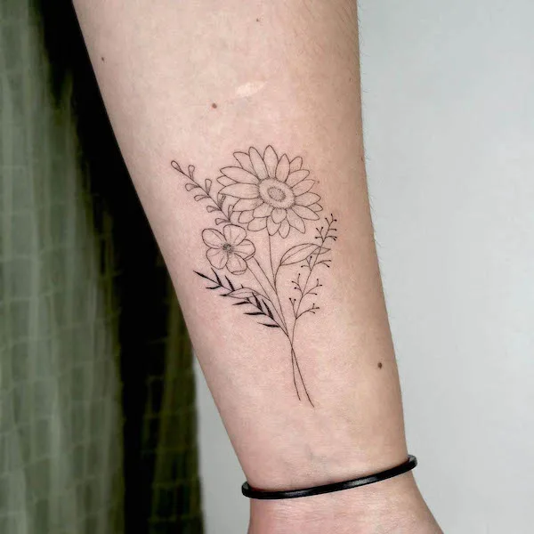 Wildflowers wrist tattoo by @maricatattoo