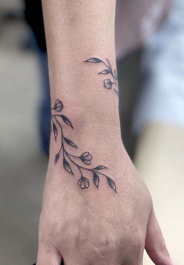Wrap around wrist tattoo by @brianna.tattoo