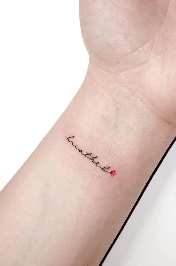 breathe lettering wrist tattoo by @playground_tat2