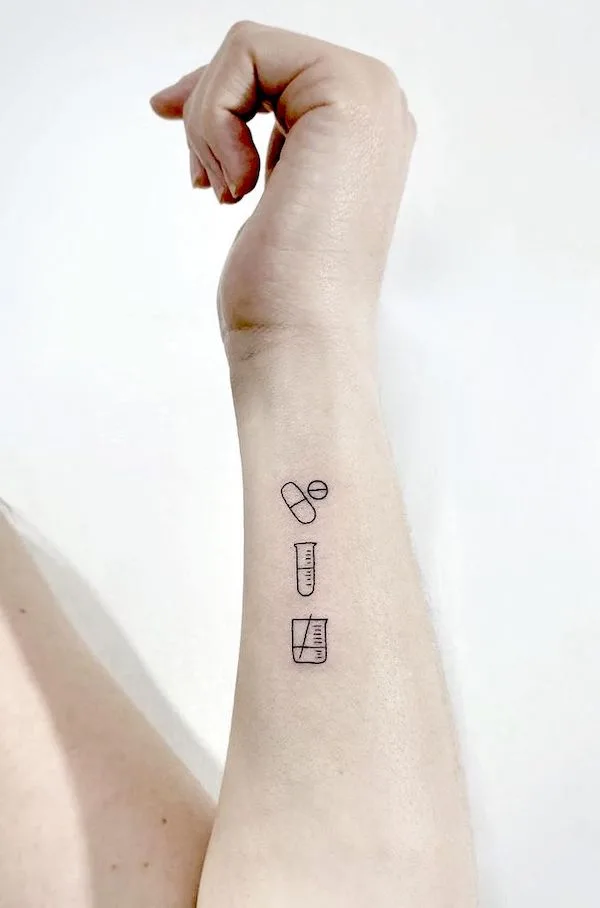 Small chemistry symbol tattoos on the wrist by @naleak_tattoo