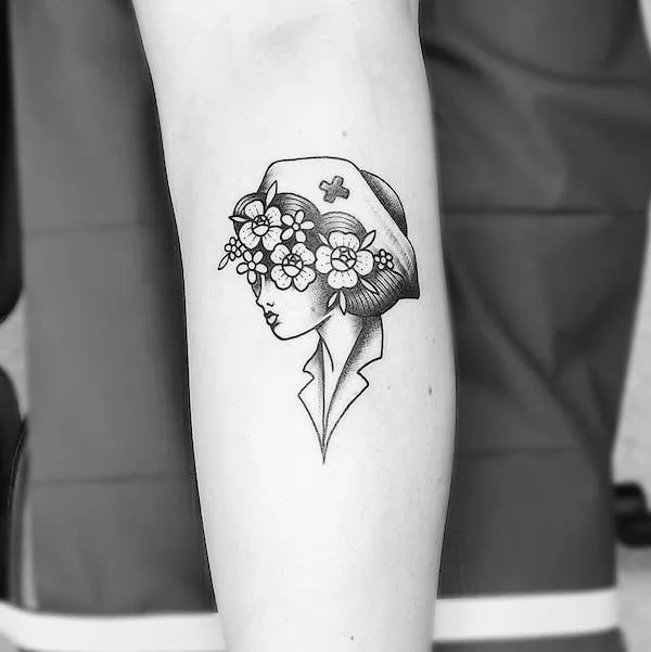 Black and grey small nurse tattoo by @tattoosbyina