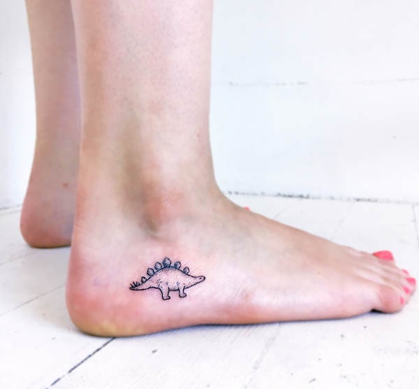 Cute small Stegosaurus foot tattoo by @ink.dust_