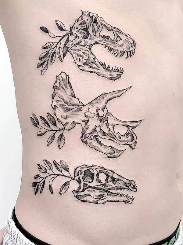 Dinosaur skull side rib tattoo by @peenutkewlee
