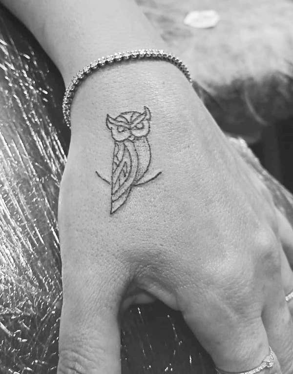Minimalist small owl hand tattoo by @chuckytattoo1