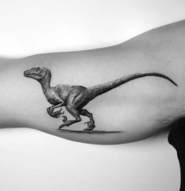 Super real Velociraptor bicep tattoo by @tattooeunb