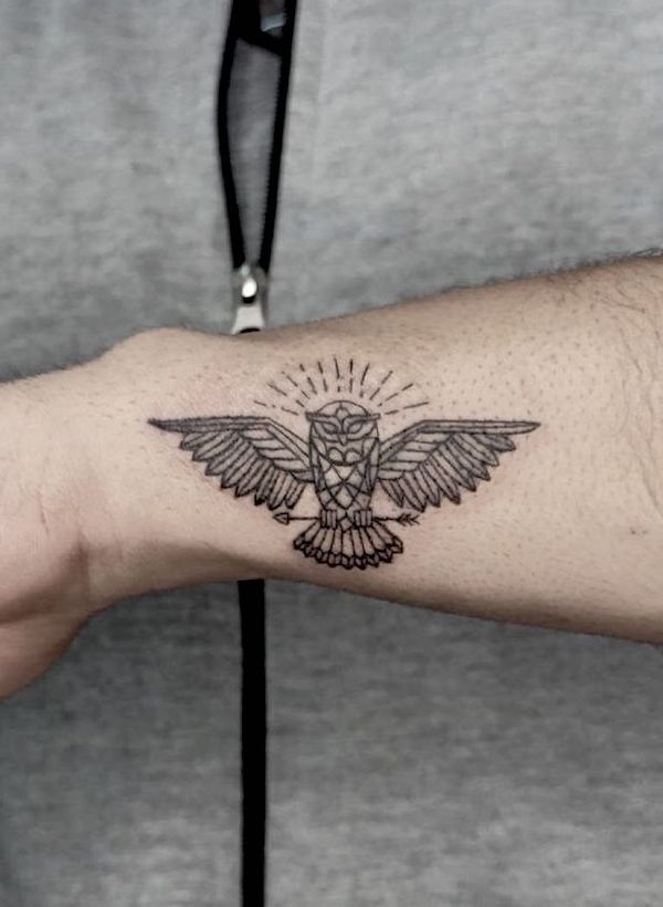 Small geometric owl tattoo on the side of wrist by @nes.hom