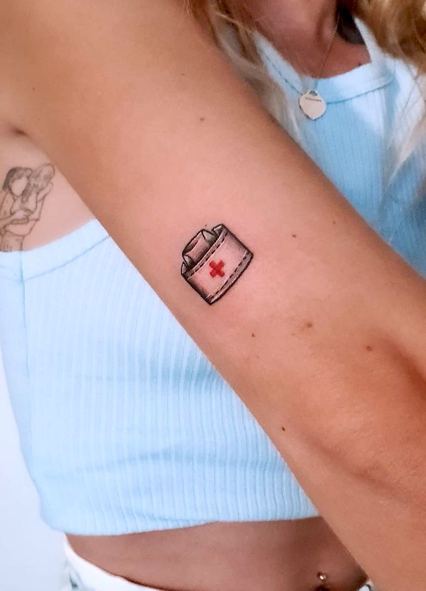 Small nurse hat arm tattoo by @rikkicarr