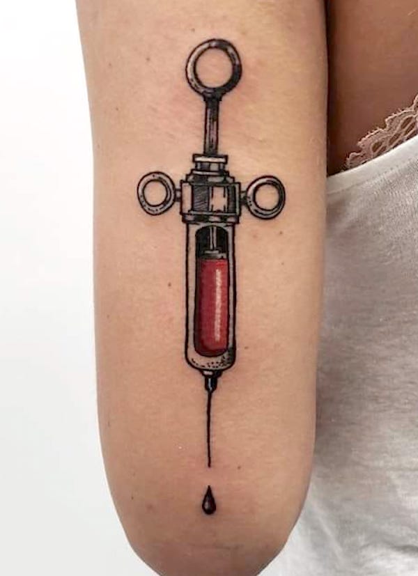 Syringe arm tattoo by @studio.tattoo.28