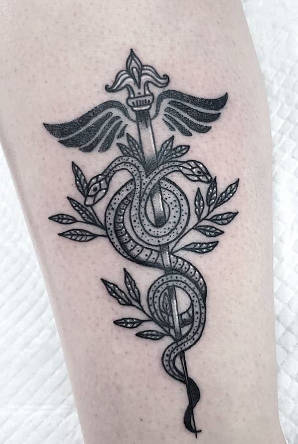 The caduceus RN symbol tattoo by @wanderingwitchtattoo