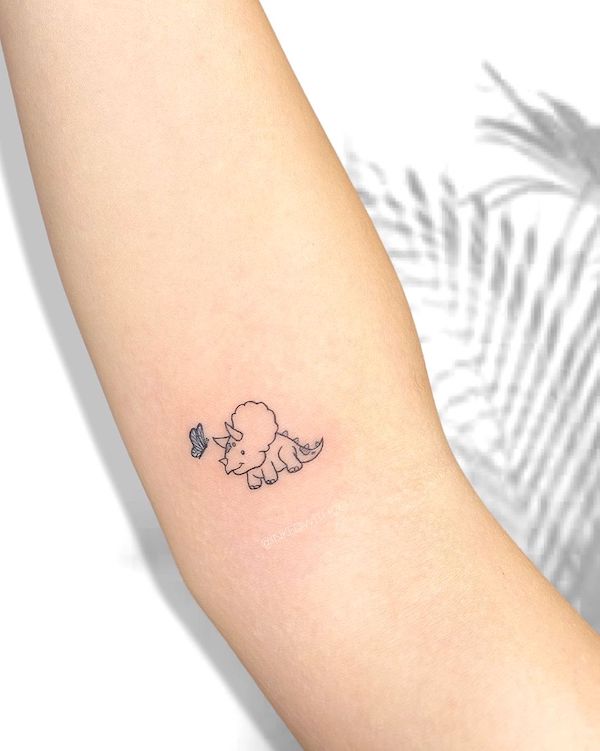 Tiny Triceratops and butterfly inner arm tattoo by @inkedwithco