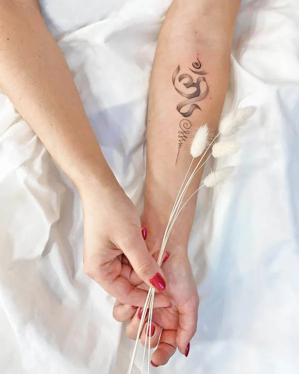 Feminine Om symbol wrist tattoo by @svet.dyak