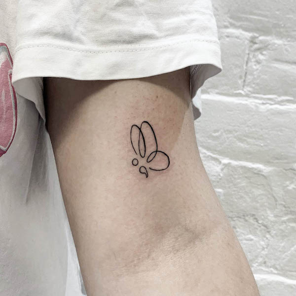 Minimalist butterfly semicolon tattoo by @maisieellistattoos