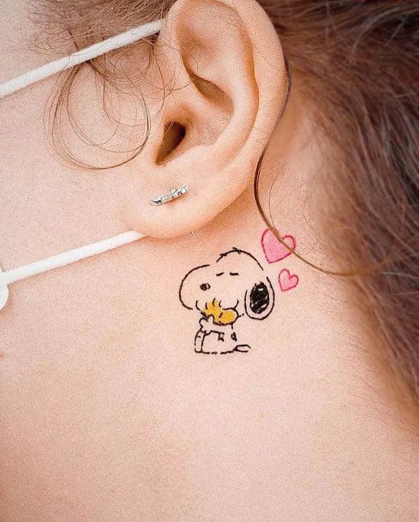 Tiny Snoopy behind the ear tattoo by @youngchickentattoo
