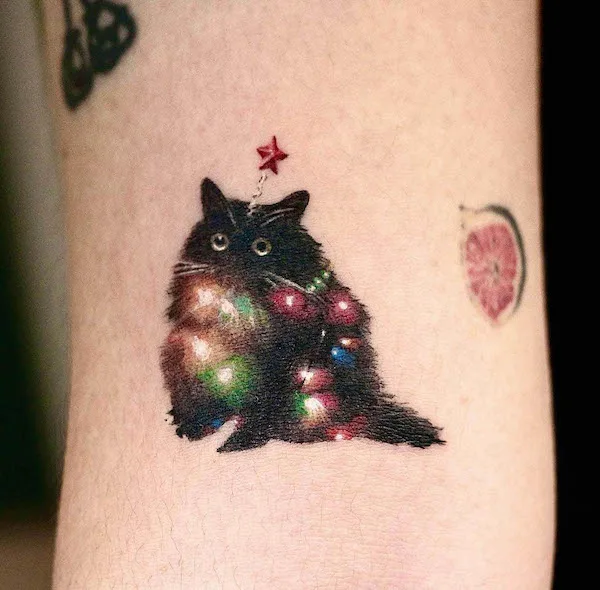 Christmas cat tattoo by @ink_yjee