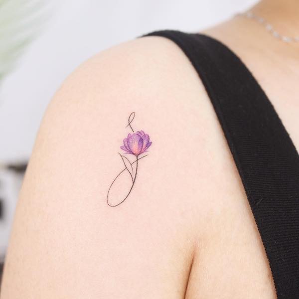 Initial J and flower tattoo by @noul_tattoo
