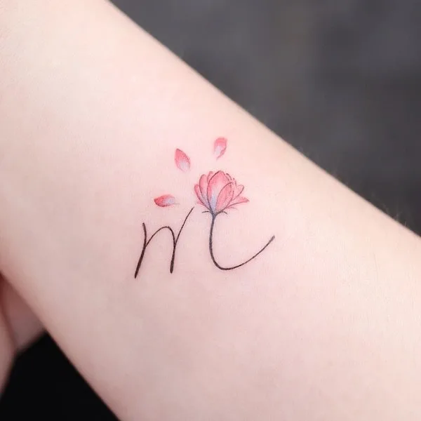 Initial M and Red sky flower tattoo by @noul_tattoo