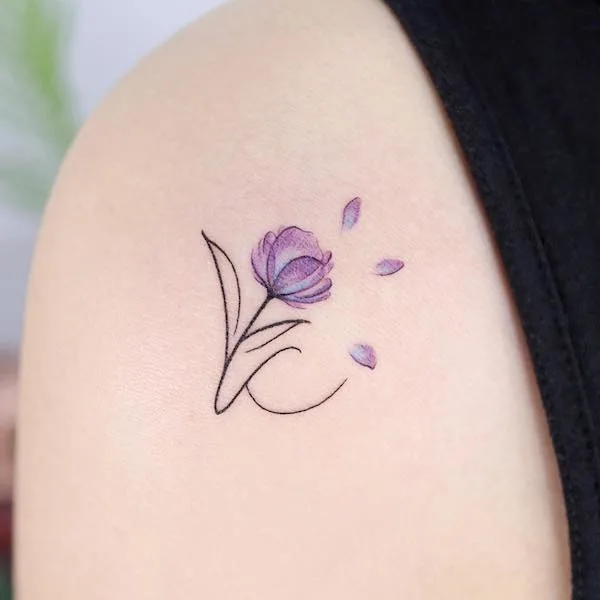 K and purple sky flower tattoo by @noul_tattoo