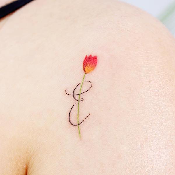 Letter E and tulip tattoo by @noul_tattoo