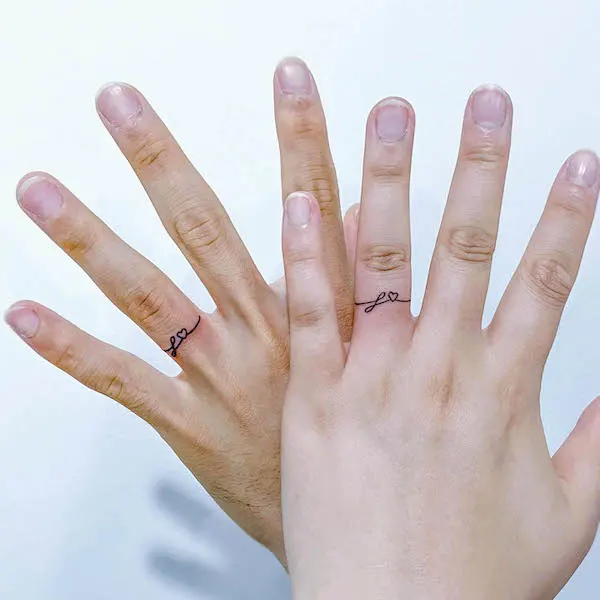 Matching ring finger tattoos for couples by @sinbar_tattoo